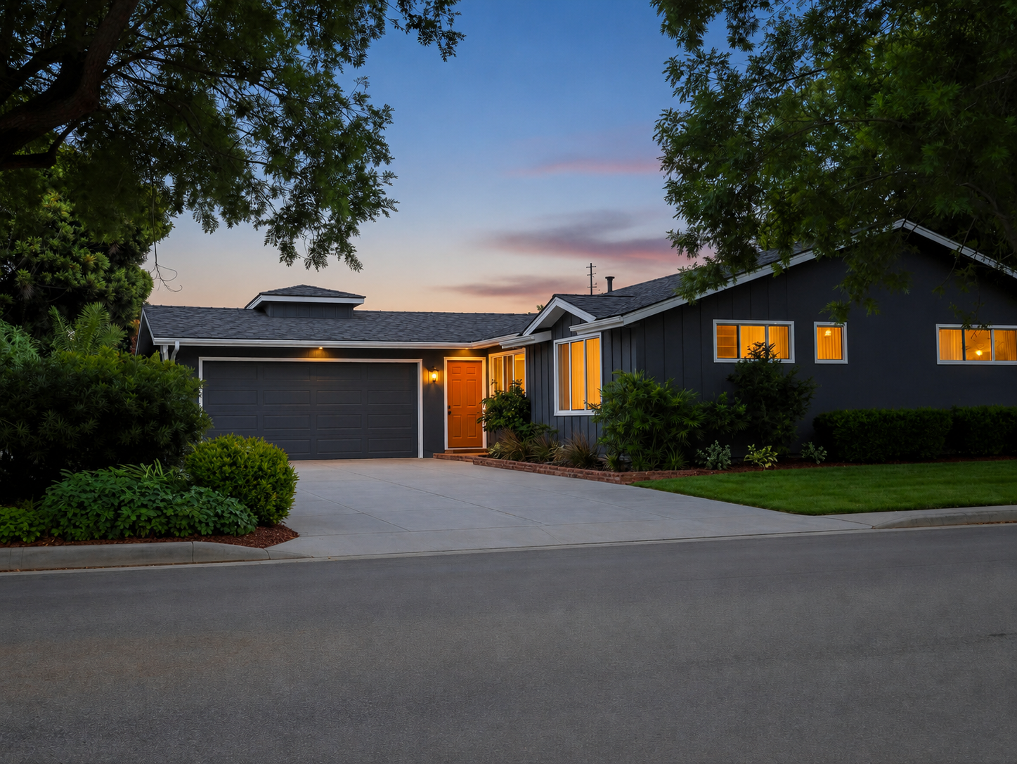 Ranch house after — deep charcoal siding, bold orange door, lush landscaping at dusk